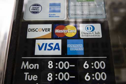 File - Credit card options are shown on a store's door on November 29, 2018 in Philadelphia