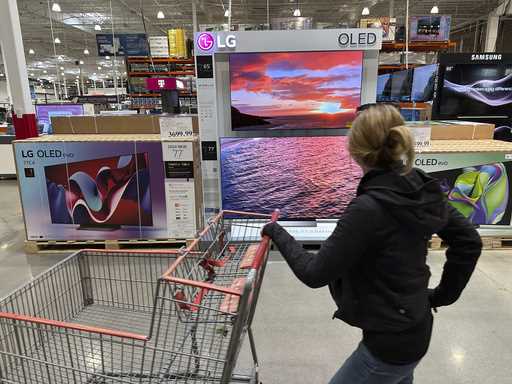 A shopper passes a display of televisions at a Costco warehouse on April 29, 2024, in Lone Tree, Co…