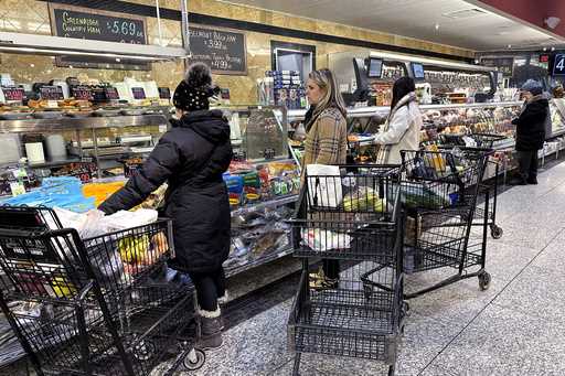 Customers wait for orders at a grocery store in Wheeling, Ill