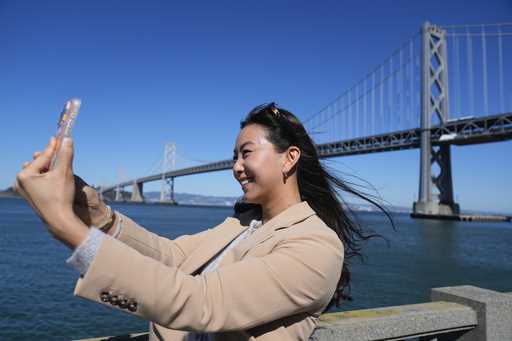 Content creator Cynthia Huang Wang works below the San Francisco-Oakland Bay Bridge in San Francisc…