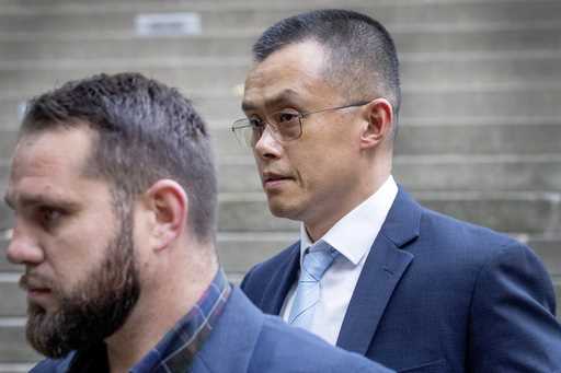 Binance founder and CEO Changpeng Zhao, right, leaves federal court in Seattle on November 21, 2023…