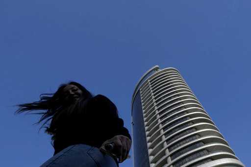 A woman reacts as she walks outside from a higher tower in central capital Nicosia, Cyprus, Wednesd…