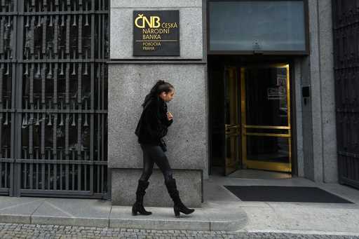 A woman walks outside the czech central bank in Prague, Czech Republic, on November 2, 2023