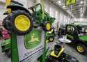 In this February 23, 2018 file photo, John Deere products, including a toy tractor on the sign, are…
