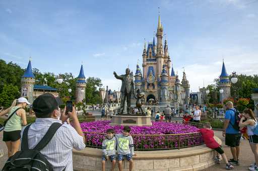 People visit the Magic Kingdom Park at Walt Disney World Resort in Lake Buena Vista, Fla