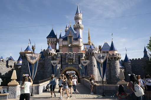 Visitors pass through Disneyland in Anaheim, Calif