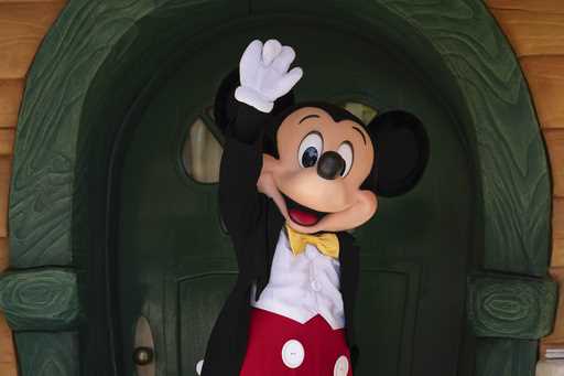 Mickey Mouse interacts with guests at Disneyland in Anaheim, Calif