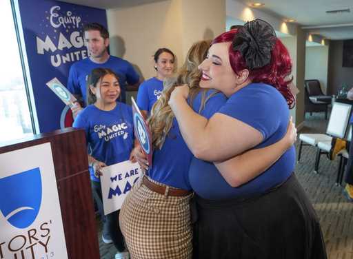 Disneyland Resort Cast Members, Courtney Griffith, left, hugs Angela Nichols after a news conferenc…