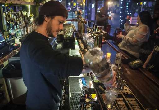 Rob Waltar, managing partner of the Fulton Grand bar, make drinks for customers, February 28, 2024,…