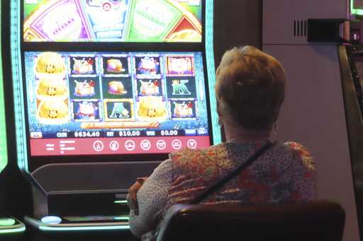 A gambler plays a slot machine at Harrah's casino in Atlantic City N