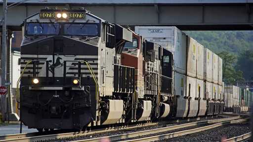 A Norfolk Southern freight train runs through a crossing on Sept