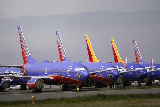 A line of Southwest Air Boeing 737 jets are parked near the company's production plant while being …