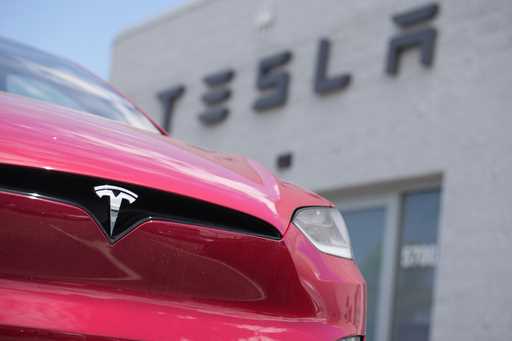An unsold 2023 Model X sports-utility vehicle sits outside a Tesla dealership Sunday, June 18, 2023…