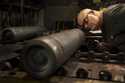 File - A steel worker inspects a 155 mm M795 artillery projectile during the manufacturing process …