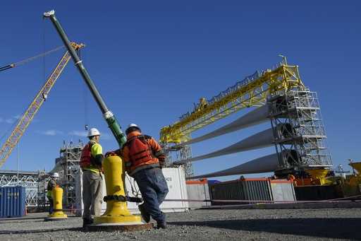 File - A generator and its blades are prepared to head to the open ocean for the South Fork Wind fa…