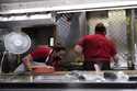 File - Women work in a restaurant kitchen in Chicago, Thursday, March 23, 2023