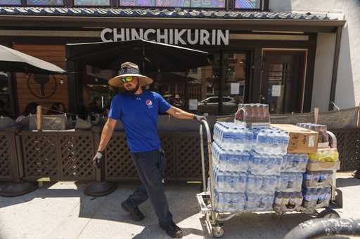 File - Driver Jose Viveros delivers beverages in the Little Tokyo district of Los Angeles, Thursday…