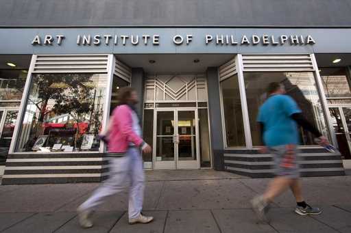 People walk past the Art Institute of Philadelphia operated by the Education Management Corporation…