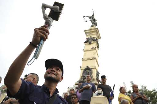 Douglas Guzman takes video with his smartphone at Liberty Plaza in San Salvador, El Salvador, Satur…
