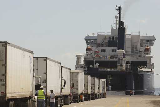 Trucks line up to be loaded into the Blue Wave Ferry during the inaugural trip between El Salvador …