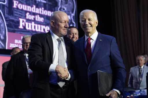 President Joe Biden talks with NABTU President Sean McGarvey after speaking to the North America's …