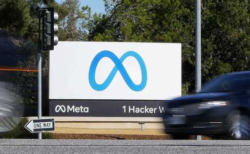 A car passes Facebook's new Meta logo on a sign at the company headquarters on October 28, 2021, in…