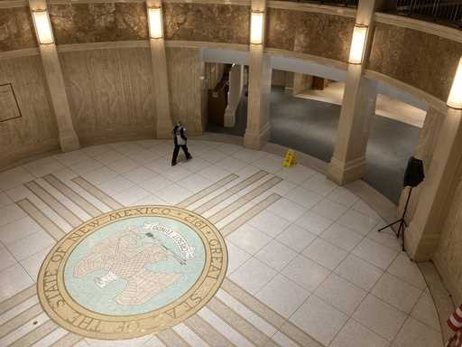 A pedestrian traverses the rotunda in the New Mexico state Capitol building in Santa Fe, N