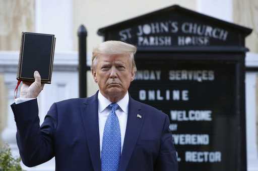 President Donald Trump holds a Bible as he visits outside St