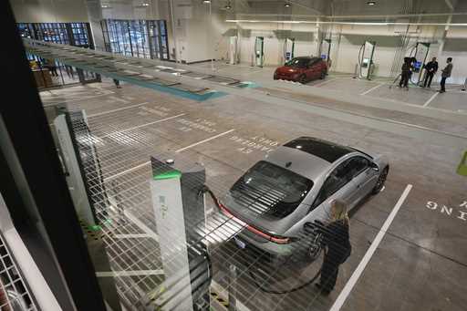 A car gets charged at the new Electrify America indoor electric vehicle charging station during a p…