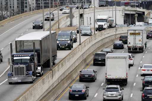 Motor vehicle traffic moves along the Interstate 76 highway in Philadelphia, March 31, 2021