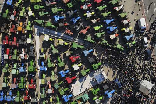 Protesting farmers with their tractors take part in a rally outside an agricultural fair in the por…