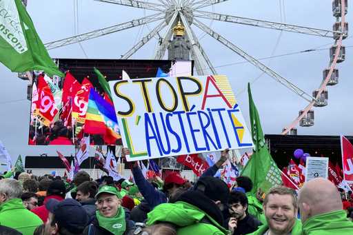 A protestor holds a sign which reads 'stop austerity' during a demonstration against austerity meas…