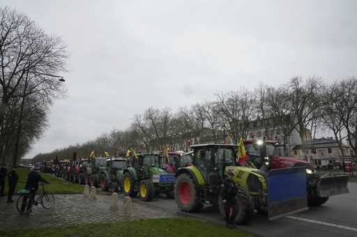 Tractors are parked during a protest, near the Chateau de Versailles, outside Paris, Friday, March …