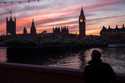 A man walks along the south bank of the River Thames backdropped by the Elizabeth Tower, known as B…