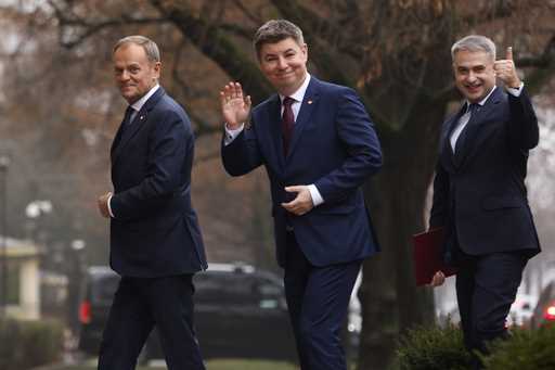 Polish Prime Minister Donald Tusk, left, Jan Grabiec, chief of staff, center, and newly appointed M…