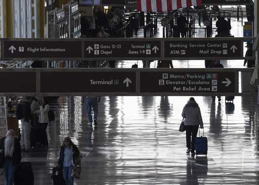 People walk the terminal at Washington's Ronald Reagan National Airport, Monday, January 25, 2016