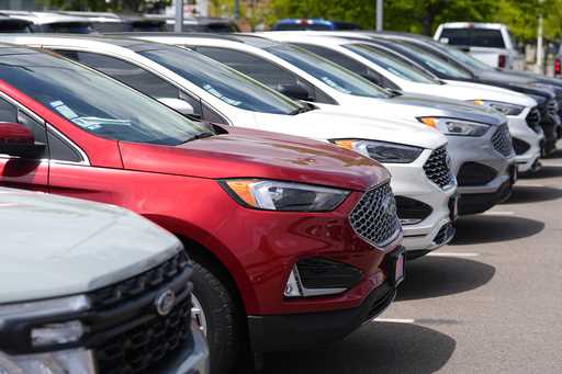 A line of unsold 2024 Edge utility vehicles sit at a Ford dealership Sunday, May 19, 2024, in Denve…
