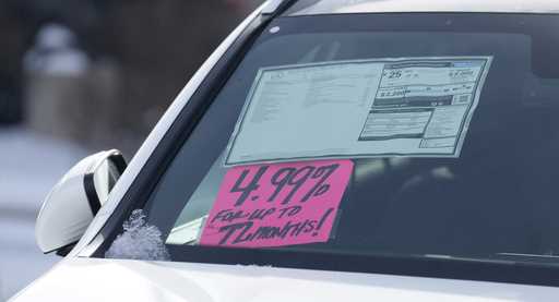 A sign highlighting the financing interest rate is displayed near the price sticker on an unsold 20…