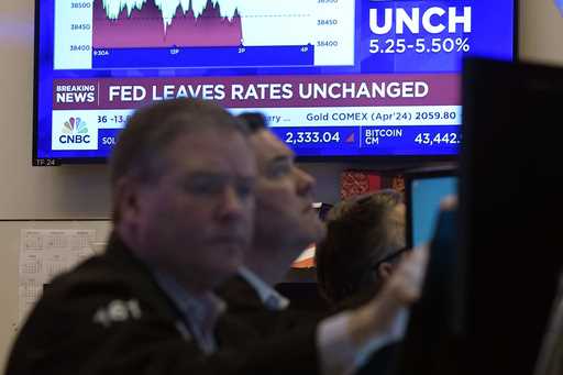 A television screen on the floor of the New York Stock Exchange displays the Federal Reserve's deci…