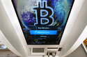 The Bitcoin logo appears on the display screen of a cryptocurrency ATM in Salem, N