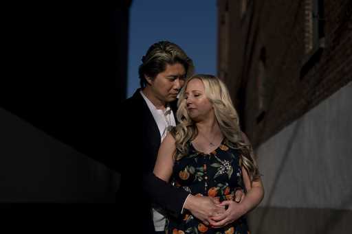 Jessica Tincopa and her husband, Rob Tran, stand for a portrait in Orange, Calif