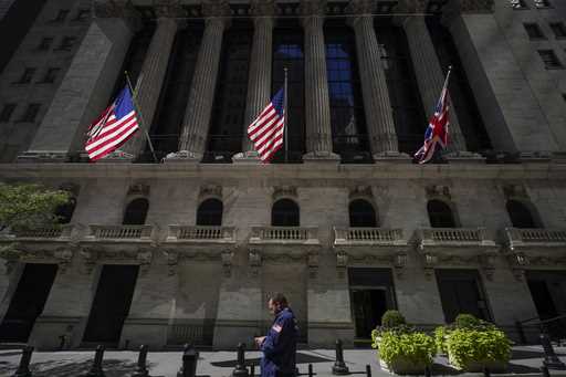 A trader looks over his cell phone outside the New York Stock Exchange, Wednesday, Sept