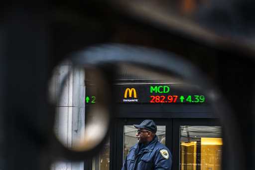 A Security member stands guard at one of the entrance of the New York Stock Exchange in New York, T…