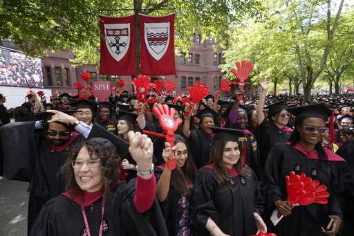 File - Graduating Harvard University students celebrate their degrees during commencement ceremonie…