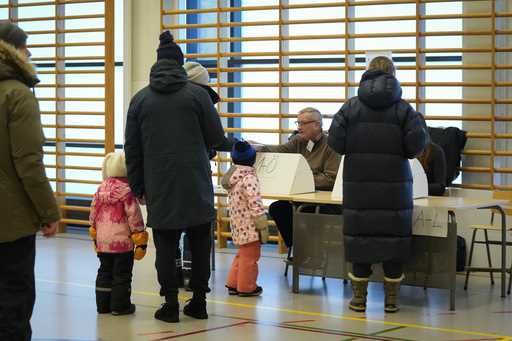 People receive their ballots at a polling station during a presidential election in Espoo, Finland,…