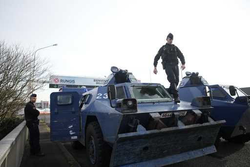 A gendarme walks atop a military vehicle at the entrance of the Rungis International Market, which …