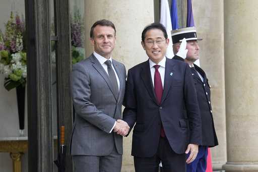 Japan's Prime Minister Fumio Kishida, left, is welcomed by France's Prime Minister Gabriel Attal, r…