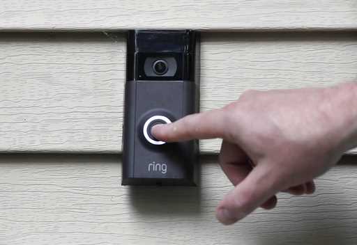 A person pushes the doorbell on his Ring doorbell camera, July 16, 2019, at his home in Wolcott, Co…
