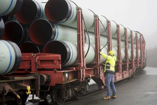 An employee works on pipes for connecting the Brunsbuettel LNG terminal to the German gas network i…