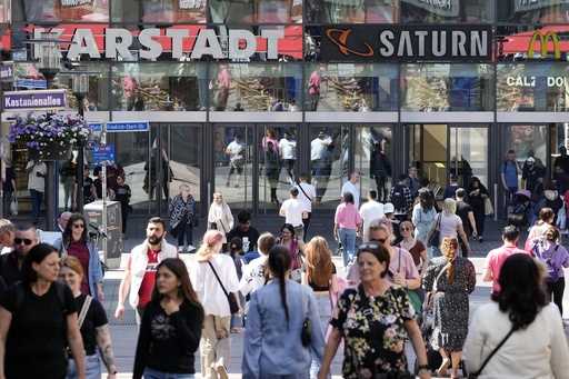 People walk on a shopping street in Essen, Germany, Wednesday, May 31, 2023